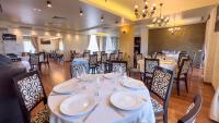 a dining room with white tables and chairs at Hotel Tolea in Târgovişte