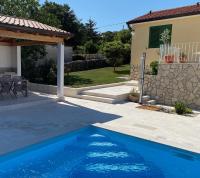 a swimming pool in front of a house at Villa Yucca Istra in Labin