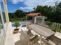 a patio with a table and chairs and a gazebo at Villa Yucca Istra in Labin