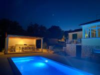 a swimming pool in front of a house at night at Villa Yucca Istra in Labin