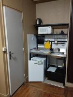 a small kitchen with a white refrigerator and a sink at Le Nid - Studios in Chartres