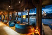 a restaurant with a view of the water at MOLO LIPNO RESIDENCE in Lipno nad Vltavou