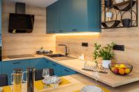 a kitchen with blue cabinets and a sink at Modern suite Beleca near Split in Solin