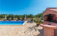 a patio with a pool with chairs and a fireplace at 4 Bedroom Amazing Home In Miranje in Miranje
