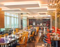 ein Restaurant mit Tischen, Stühlen und Fenstern in der Unterkunft W Suzhou - Jinji Lake in Suzhou