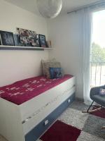 a small bed in a room with a window at Logement spacieux idéal famille in Marseille