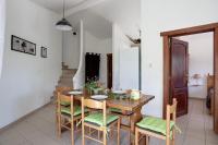 a dining room with a wooden table and chairs at Apartments La Vieille Source in Saint-Martin-dʼArdèche