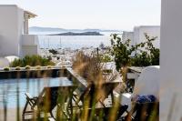a balcony with chairs and a view of the water at She Mykonos Boutique Hotel in Mýkonos City