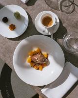 a table with a plate of food and a cup of coffee at Il Castello Di San Gaudenzio in Cervesina