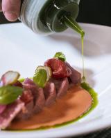 a person is pouring syrup onto a piece of food at Il Castello Di San Gaudenzio in Cervesina