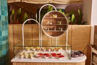 a display case filled with different types of food at TRS Ibiza Hotel - Adults Only in San Antonio