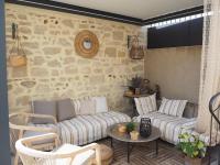 a living room with a couch and a table at Small holiday home with courtyard, Bellegarde in Bellegarde