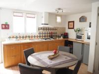 a kitchen with a table with a fruit on it at Small holiday home with courtyard, Bellegarde in Bellegarde