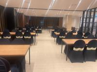 a room with rows of tables and chairs at Tamara Jeju hotel in Seogwipo