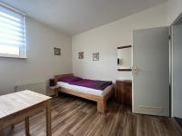 a bedroom with a bed with purple sheets and a window at Apart Pension Plaue in Brandenburg an der Havel