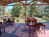 un grupo de mesas y sillas bajo un pabellón en Blend Lodge and Kitchen, en Zomba