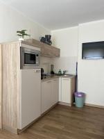 a kitchen with a refrigerator and a microwave at Apart Pension Plaue in Brandenburg an der Havel