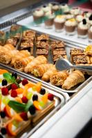 a display case with different types of pastries and desserts at Hotel Olympus in Caorle