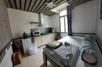a bedroom with a large bed and a window at Gite de la tour, proche Nîmes ,Avignon in Montfrin