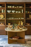 a table with bowls and other ceramics on shelves at Baumanière - Les Baux de Provence in Les Baux-de-Provence