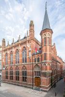 a large red brick building with a clock tower at Hotel Staatsman in Zwolle