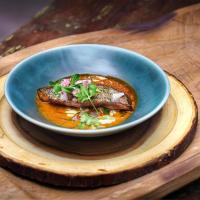 a blue bowl of food on a wooden plate at Samed Tamarind Beach Resort in Ko Samed