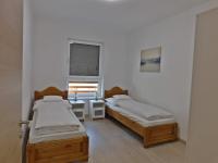 Posteľ alebo postele v izbe v ubytovaní Berki Apartman