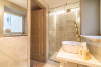 a bathroom with a tub and a sink and a shower at The Melegran in Rovinj