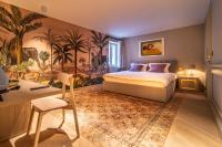 a bedroom with a large bed and a painting on the wall at The Melegran in Rovinj