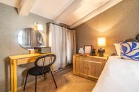 a bedroom with a bed and a desk and a chair at The Melegran in Rovinj