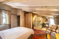 a bedroom with a large white bed and a chair at The Melegran in Rovinj