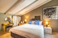 a bedroom with a large bed with blue and white pillows at The Melegran in Rovinj