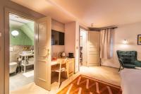 a room with a bathroom and a bedroom with a sink at The Melegran in Rovinj