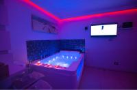 Televízia a/alebo spoločenská miestnosť v ubytovaní B&B suite spa la Sciantosa