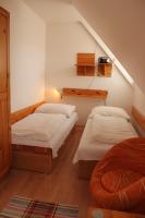 A bed or beds in a room at Penzión U Johna