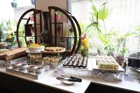 a buffet of desserts and pastries on a table at Sachika Hotels, Guwahati in Guwahati