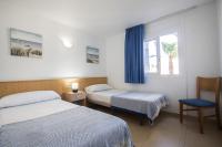 Posteľ alebo postele v izbe v ubytovaní Apartamentos Torre Yago