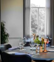 a table with wine glasses on it with a window at Vejlsøhus Hotel and Conference Center in Silkeborg