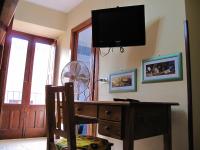 A television and/or entertainment centre at Diving Center Punta Stilo