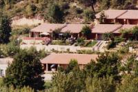 a group of buildings with trees in front of them at Le seringat 46 in Saint-Martin-de-Brômes