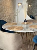 a table with four plates on it with chairs at L&#39;Etoile - Duplex cosy de 50m2 en centre-ville in Nîmes