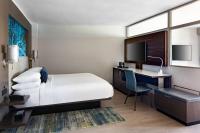 a hotel room with a bed and a desk and a tv at San Juan Marriott Resort and Stellaris Casino in San Juan