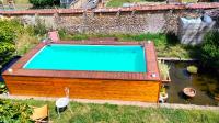 an overhead view of a swimming pool with a roof at Chez Aurélia - Chambres &amp; Table d&#39;hôtes in La Couture-Boussey