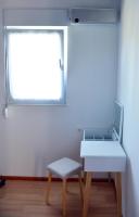 a desk and a chair in a room with a window at Kuća za odmor Čanić gaj in Gospić