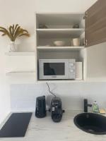 a kitchen counter with a microwave and a sink at Mimosa* Proche Centre-Ville et CHU*Parking in Amiens