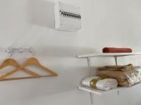 a room with a white wall with a shelf and a bag at Mimosa* Proche Centre-Ville et CHU*Parking in Amiens