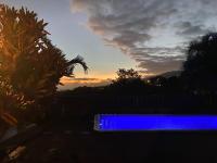 a blue bench with the sunset in the background at Cocooning Tropic Studio avec Jacuzzi privatif in Saint-Louis