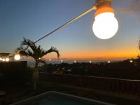 a view of a sunset from a house with a light at Cocooning Tropic Studio avec Jacuzzi privatif in Saint-Louis
