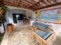 a living room with a couch and a table at Cocooning Tropic Studio avec Jacuzzi privatif in Saint-Louis