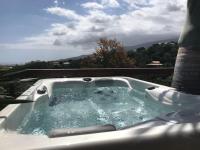 a jacuzzi tub with a view of the ocean at Cocooning Tropic Studio avec Jacuzzi privatif in Saint-Louis
